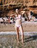 A model in the Araks tessa bikini top and piper bikini bottom in ballet pink