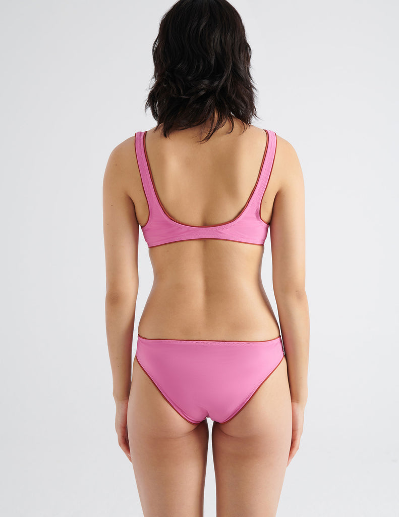 On model image of the backside of the pink bikini bottom and top 