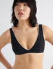 On model, 3/4 image of black bikini top