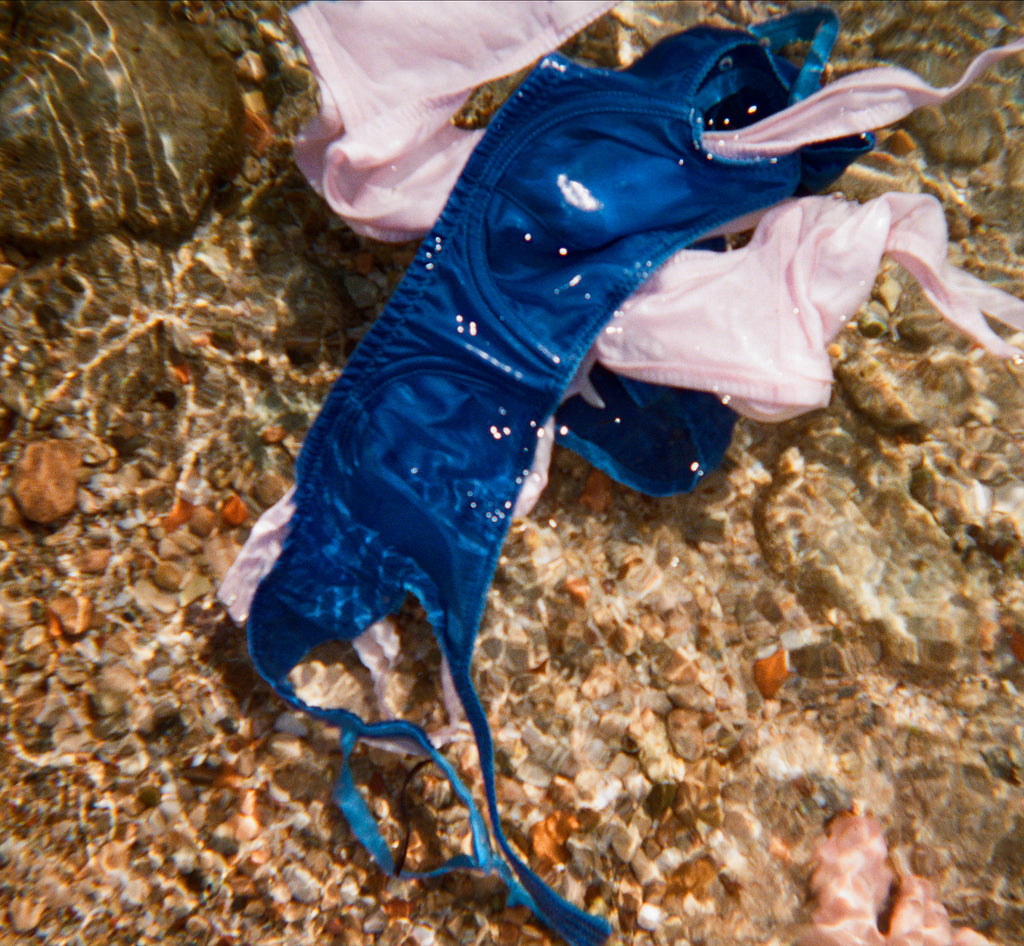 Blue and pink lingerie sets in water.