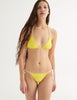 on model, a front facing photo of the yellow nelle string bikini with white trim
