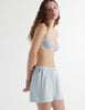 Side view of the woman wearing cloud blue sofia underwire cotton bra with silk eduardo boxer