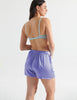 back of woman in purple silk cami and short