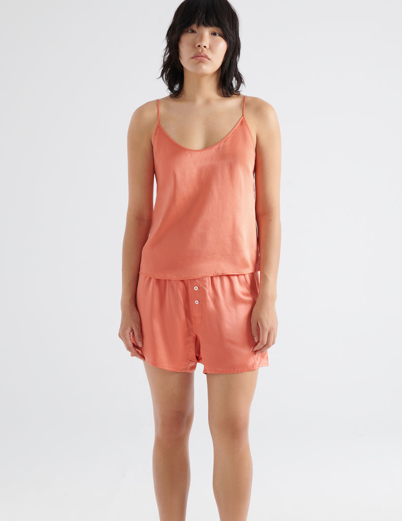 On model front view of pink pajama shorts and silk cami