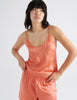 Upper body image of pink silk cami and pajama short.
