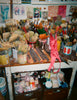 An art studio with paint brushes and a hanging bra.