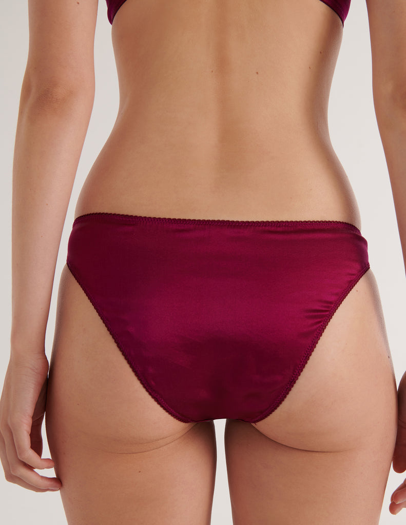A model in the araks silk gwyneth panty in cranberry red