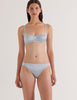 A model in the araks silk penelope bralette and gwyneth panty in glace blue