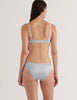 A model in the araks silk penelope bralette and gwyneth panty in glace blue