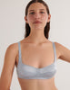 A model in the araks silk penelope bralette in glace blue