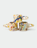 Three ceramic Peter Shire mugs with colorful abstract patterns on a white background