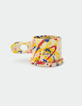 Colorful splatter-patterned Peter Shire mug on a white background