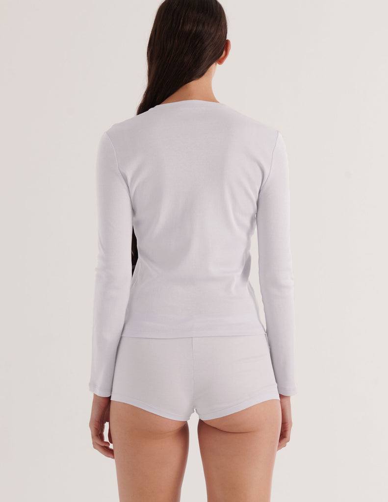 a model from the back in the araks sabine organic cotton and presley short in white