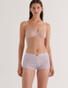 A model in the araks organic cotton antonia bralette and presley short in fairy lavender