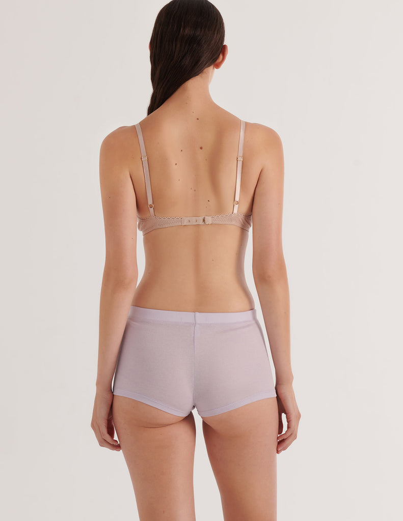 A model in the araks organic cotton antonia bralette and presley short in fairy lavender