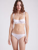 front view of woman wearing white silk bra and panty 