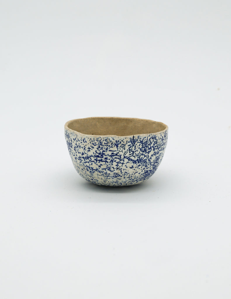 A small blue speckled bowl by Lisa Kaye