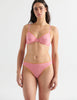 Front view image of model wearing pink cotton thong with yellow trim and matching underwire bra. 