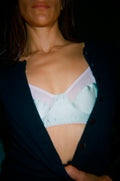 A close up of a person wearing a blue bra.
