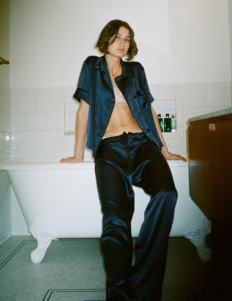 Woman  wearing an Araks  Navy Sea  Pajama Set a in a bathroom.