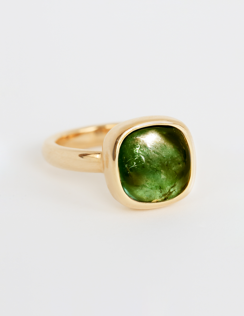 Gold ring with green gem.