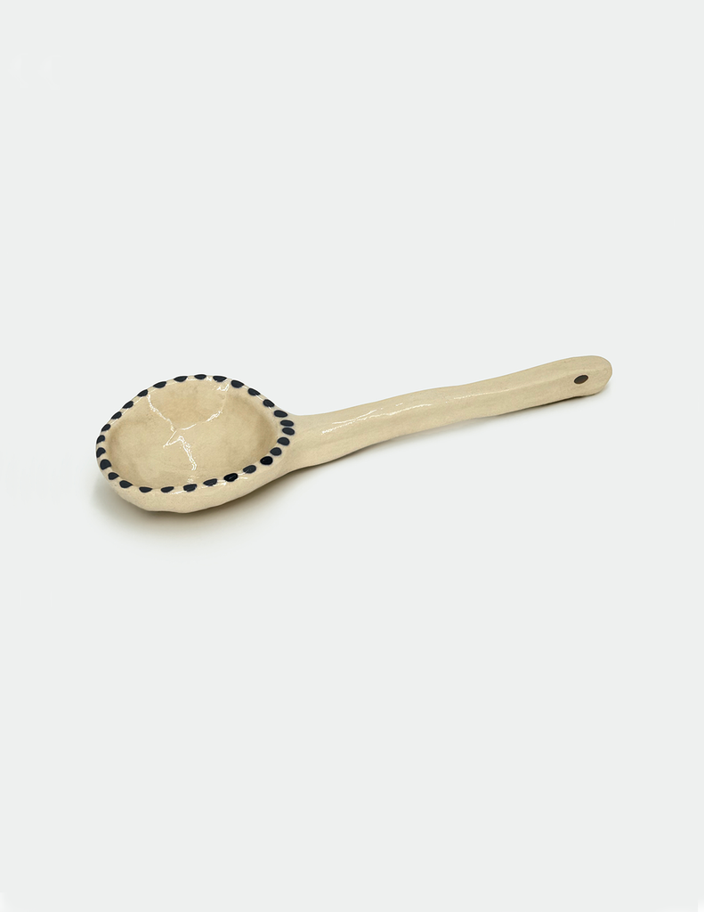 a handmade ceramic spoon by lisa kaye