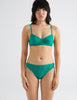 front view image of model wearing green lace bralette and panty