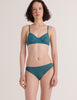 A model from the front view in the araks french stretch lace tamara bralette and tris panty in heron blue
