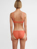 back view on model of woman in orange bra and panty