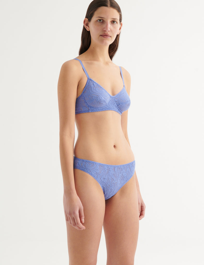 a close up image of a model in the tamara bralette and tris panty in serene blue