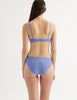 an image from the back of a model in the tamara bralette and tris panty in serene blue