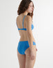 Back view of the woman wearing iris blue cotton uma bra with harriet panty