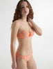 Side view of the woman wearing lush orange cotton uma bra with harriet panty