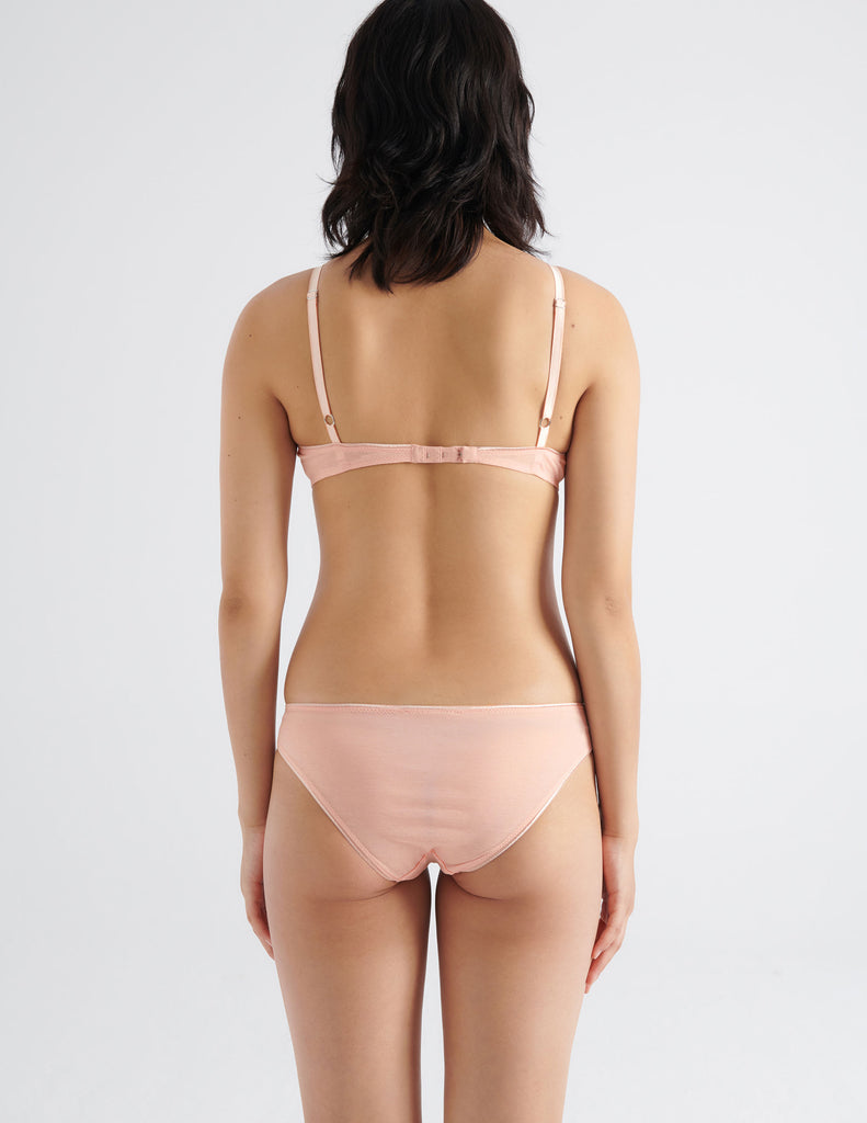back view of woman wearing peach cotton bra and panty