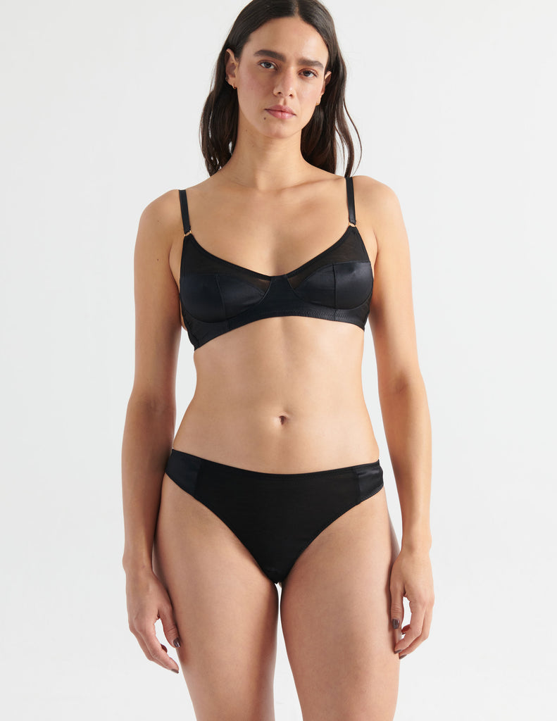 Woman in black cotton and silk bralette and thong