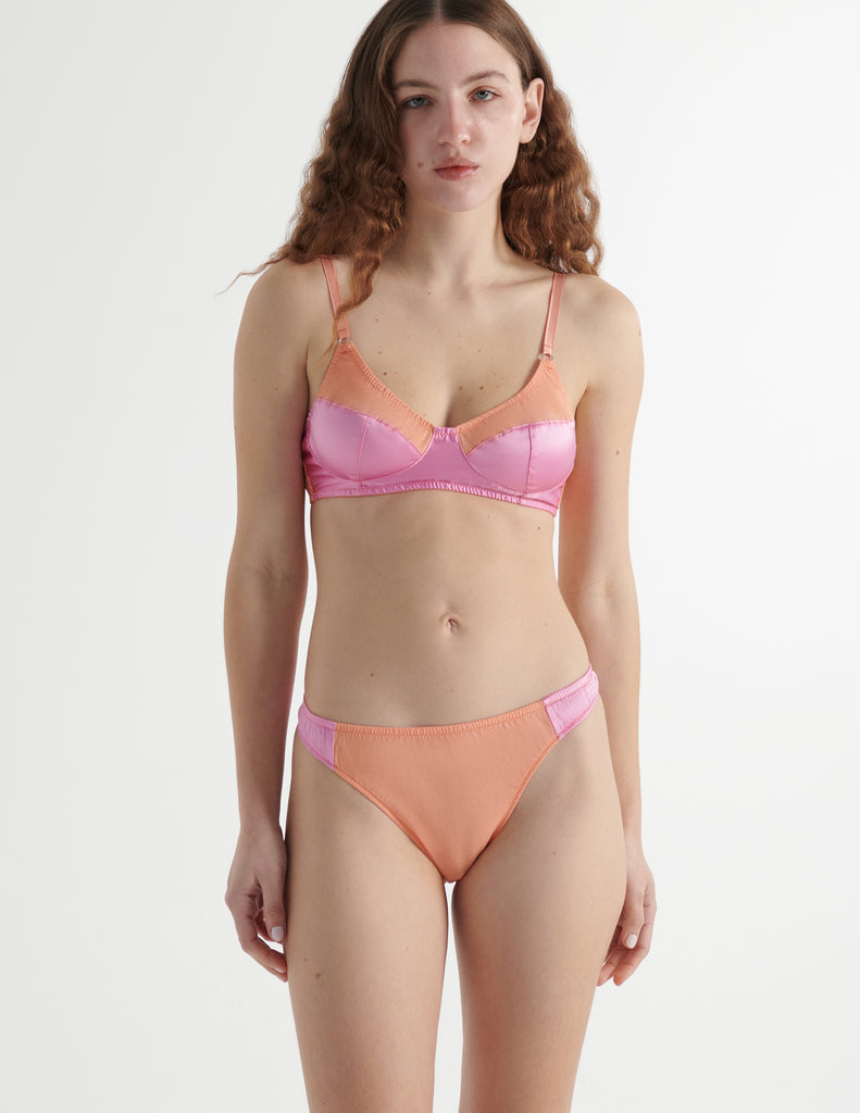 Front view of the model wearing lush orange silk willow bra with maude thong