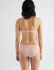 back view of woman in nude silk bra and panty