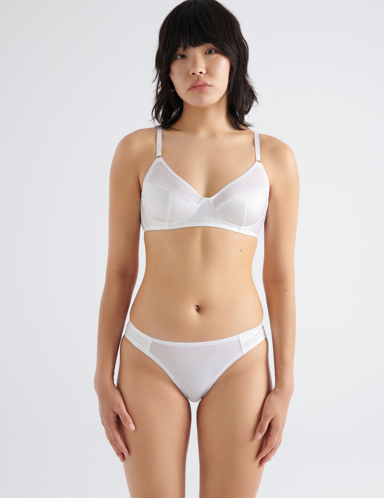 Woman in white cotton and silk bra and panty