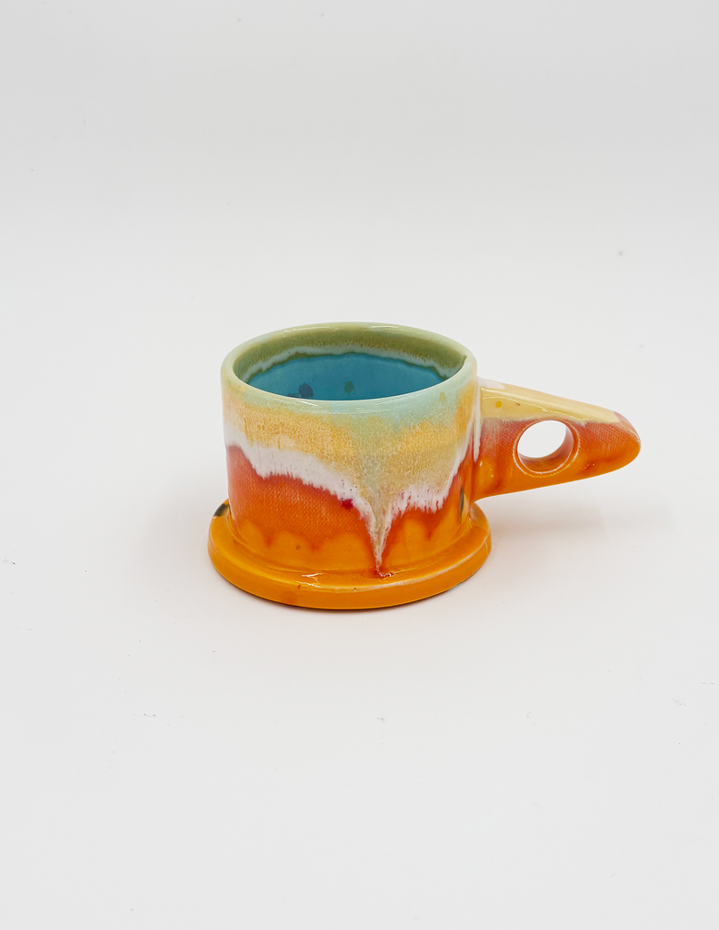 A peter shire sculptural handmade mug with a triangle handle