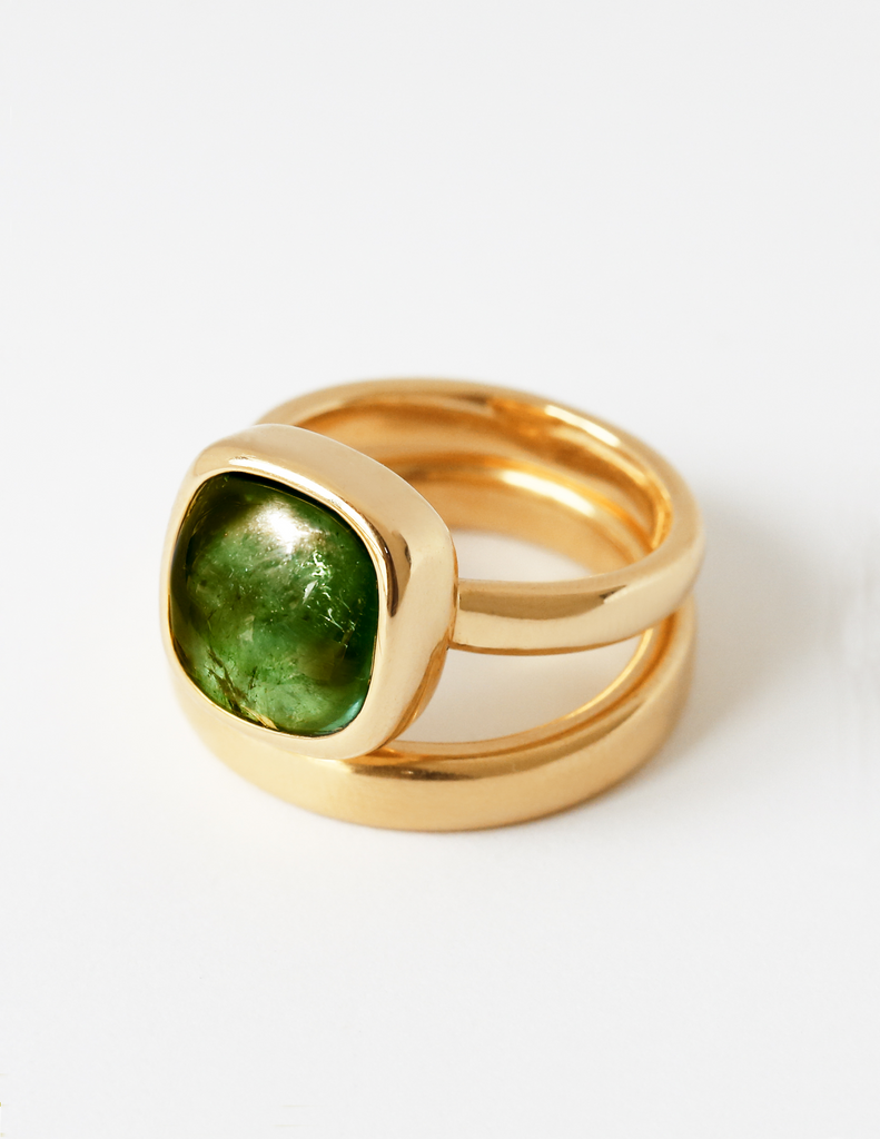 Gold ring with green gem.