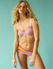On model image of 3 cotton panties (red, yellow, pink) with a pink cotton bralette with red lace tri, 