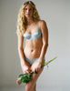 woman in blue silk bra and panty and flowers
