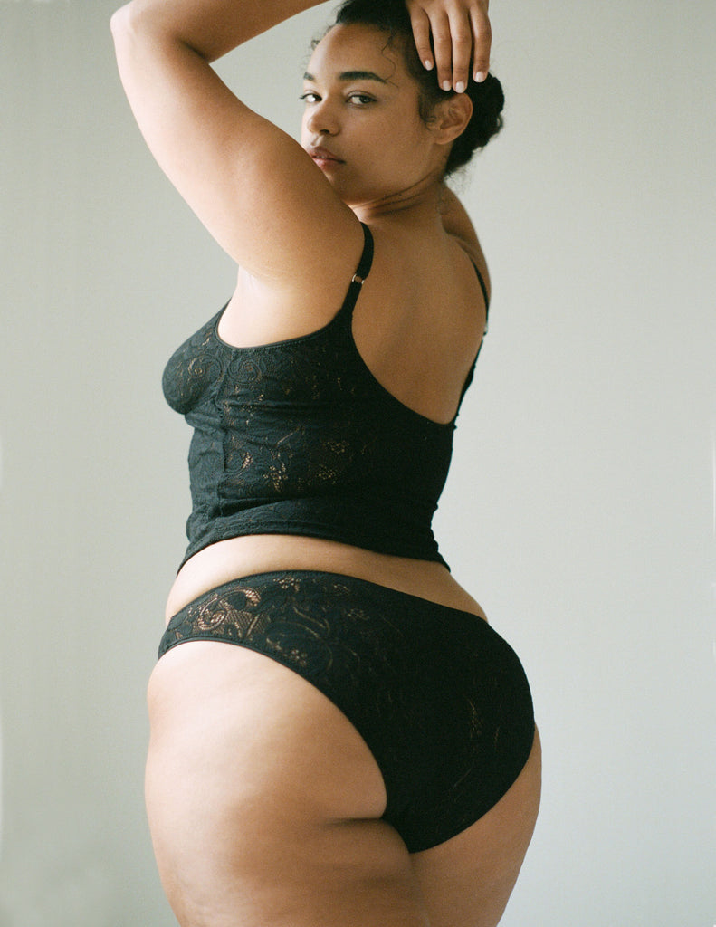 back view of woman wearing Black, lace low rise panty with matching tank