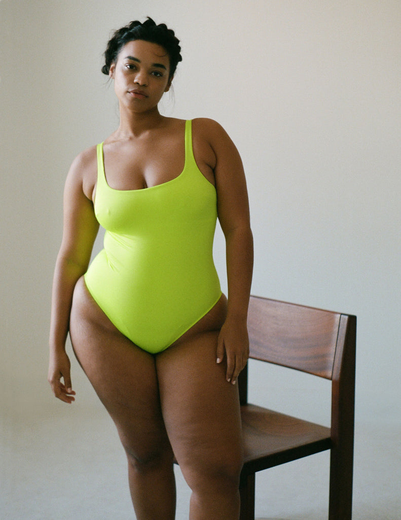woman wearing simple neon one piece swimsuit