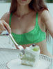woman in green silk bra