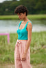 woman wearing green top and pink pants