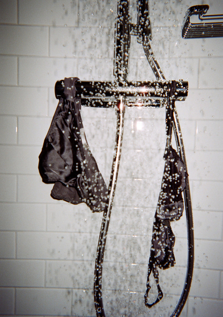 Shower running, brown bralette with dark brown panel and matching panty hanging on bar