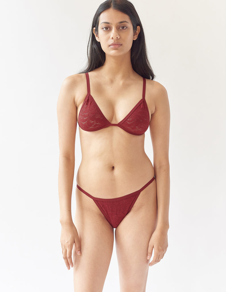 woman wearing red lace triangle bralette and matching panty by Araks
