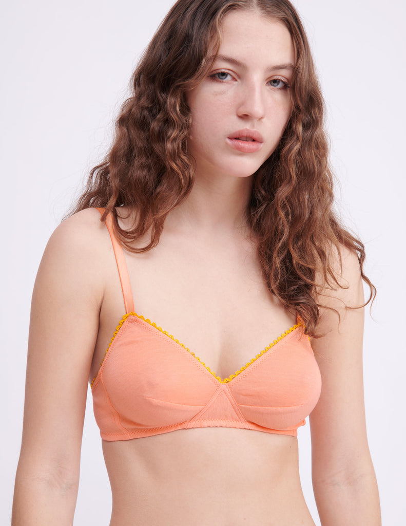 close up of woman in orange bra