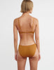 woman wearing brown cotton wireless bralette with pink trim and matching panty by Araks